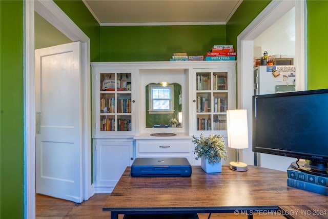 interior space featuring dark hardwood / wood-style flooring and ornamental molding