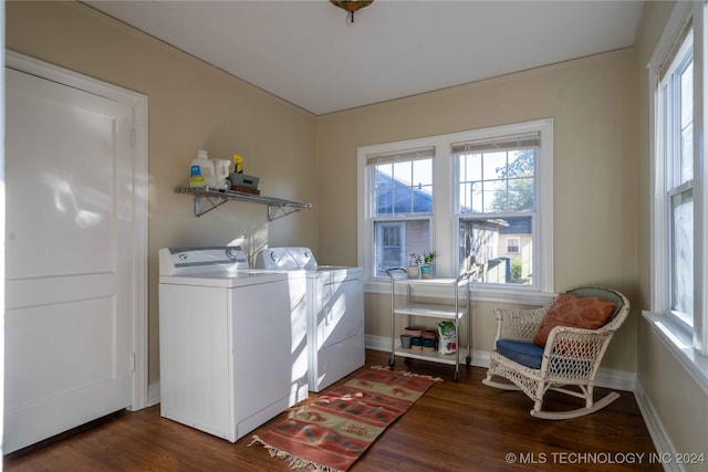 clothes washing area featuring washing machine and dryer and dark hardwood / wood-style flooring