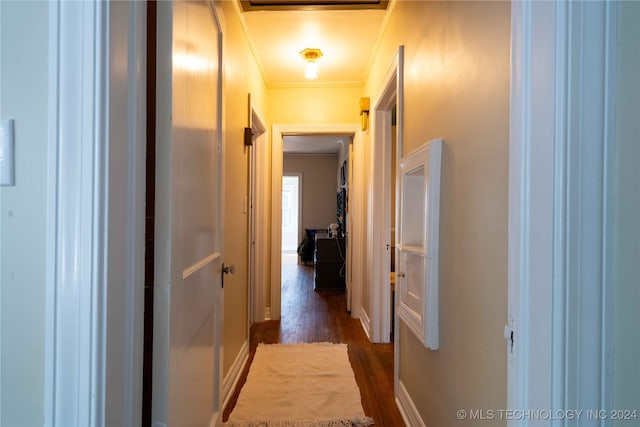 hallway featuring dark hardwood / wood-style flooring and ornamental molding