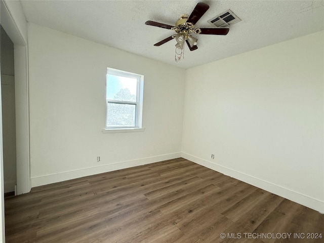 unfurnished room featuring a textured ceiling, dark hardwood / wood-style flooring, and ceiling fan