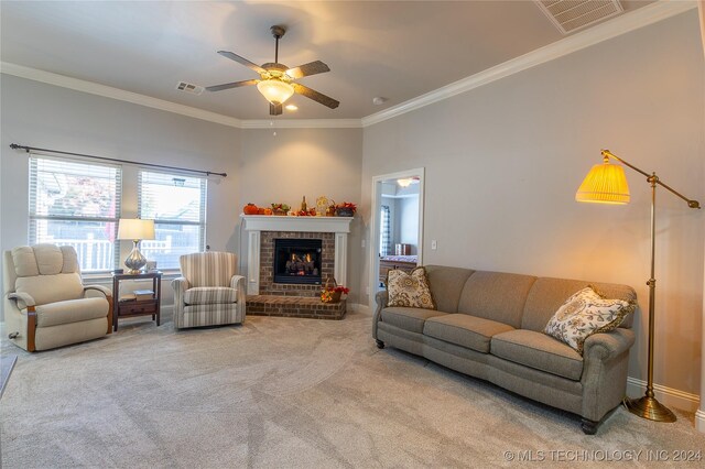 carpeted living room with a fireplace, ceiling fan, and crown molding