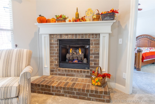 room details featuring carpet flooring and a fireplace