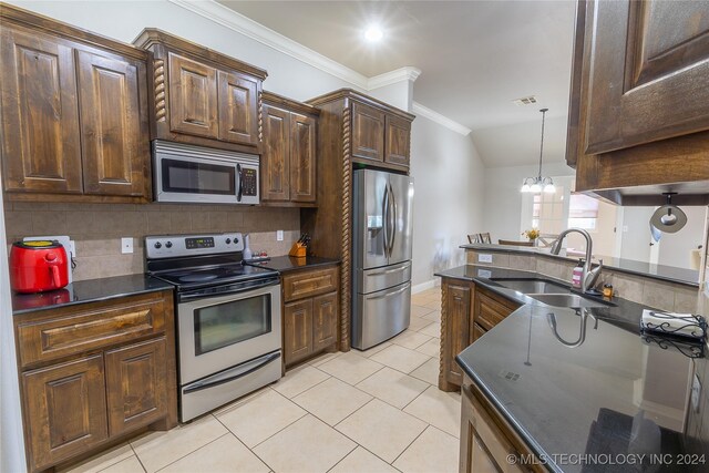 kitchen featuring sink, stainless steel appliances, tasteful backsplash, crown molding, and a chandelier