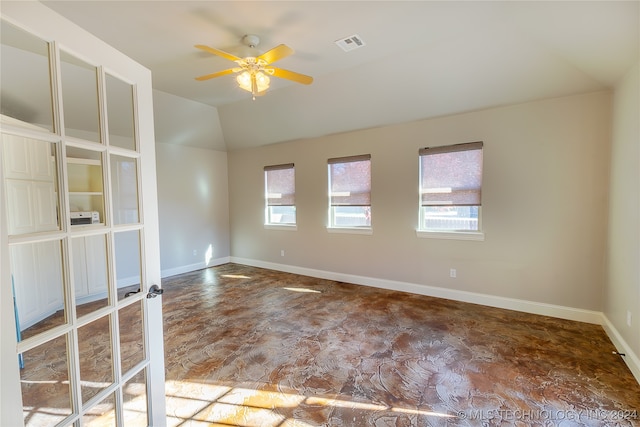 unfurnished room with ceiling fan and lofted ceiling