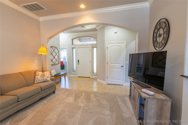 living room featuring light tile patterned floors and crown molding