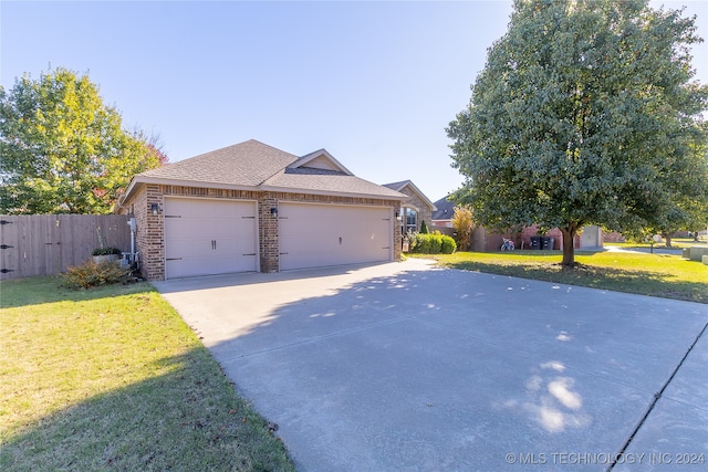 view of front of home with a garage and a front yard