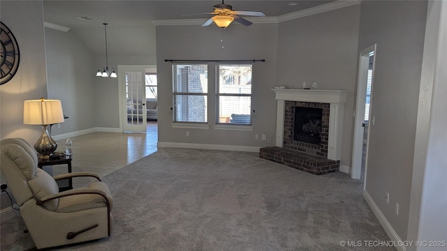 carpeted living area featuring baseboards, a fireplace, ornamental molding, tile patterned flooring, and ceiling fan with notable chandelier