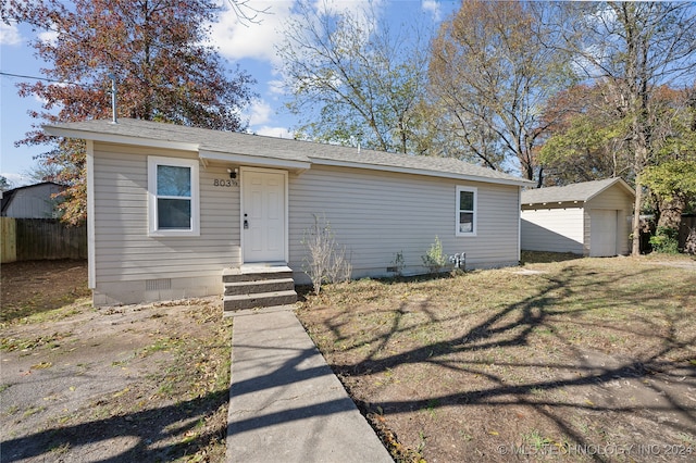 view of front of property featuring an outdoor structure and a garage