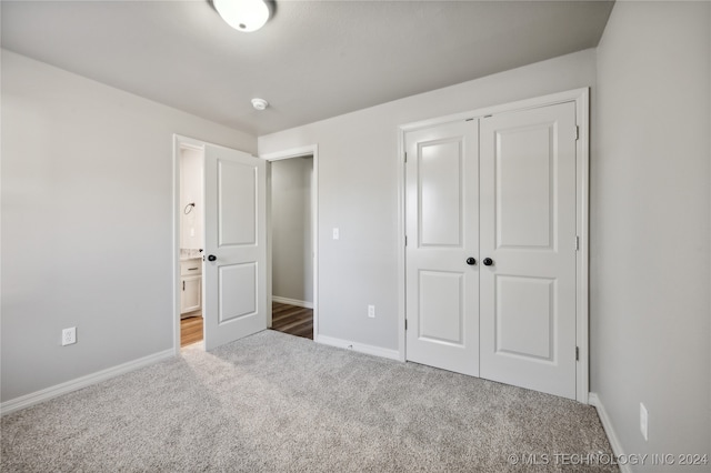 unfurnished bedroom with carpet and a closet