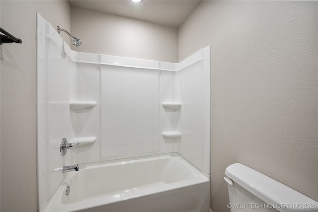 bathroom featuring toilet and bathing tub / shower combination