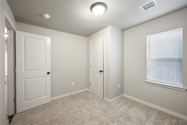 unfurnished bedroom with light carpet