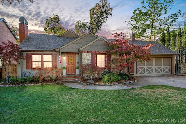 view of front of property with a lawn and a garage