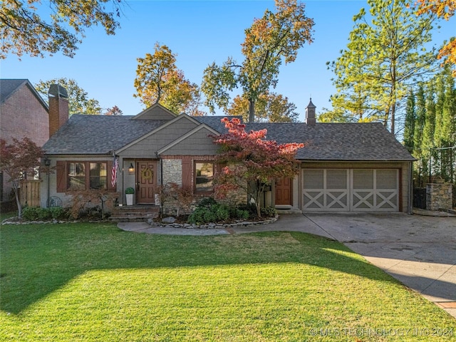 view of front of home featuring a front yard and a garage