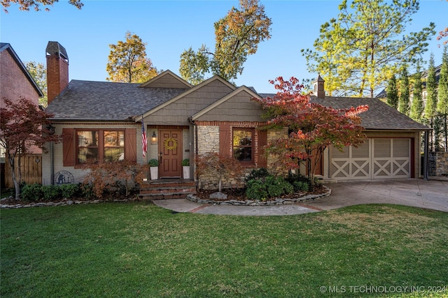 view of front of property featuring a front yard and a garage