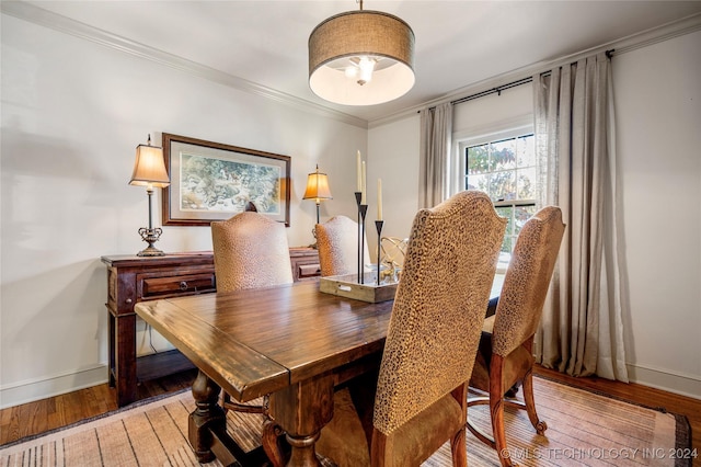 dining area with light wood-type flooring and crown molding