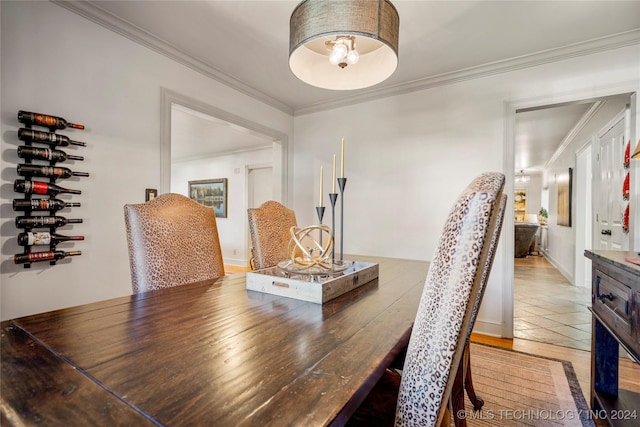 dining area featuring crown molding and wood-type flooring