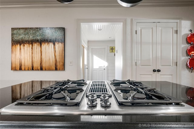 details with range, stainless steel gas cooktop, and crown molding