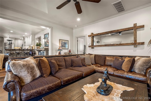 living room with crown molding and hardwood / wood-style floors