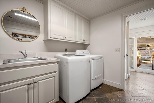 laundry room featuring washer and clothes dryer, cabinets, wooden ceiling, and sink