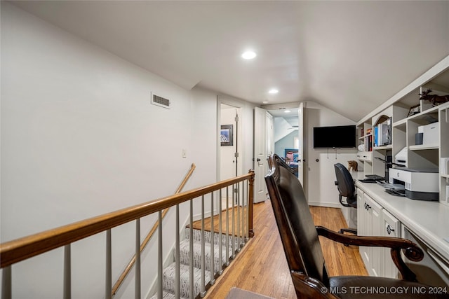 office space featuring light hardwood / wood-style flooring and vaulted ceiling