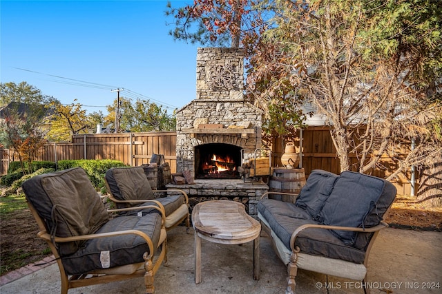 view of patio / terrace featuring an outdoor stone fireplace