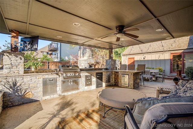 view of patio / terrace featuring grilling area, ceiling fan, and exterior kitchen