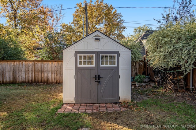 view of outbuilding featuring a yard