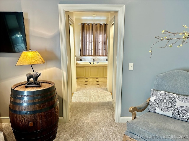 hallway featuring light colored carpet