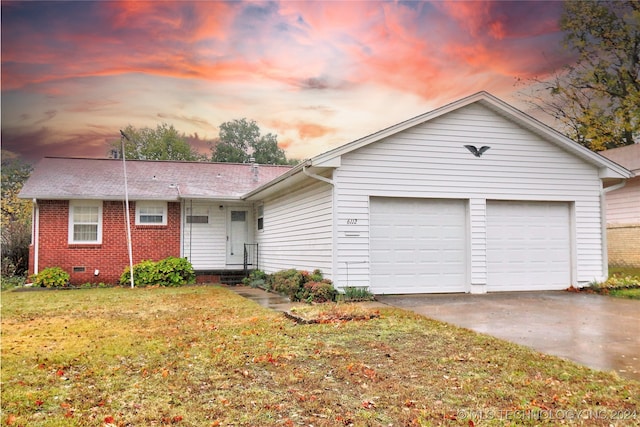 single story home with a garage and a lawn