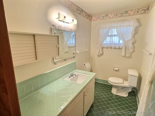 bathroom featuring tile patterned floors, vanity, and toilet