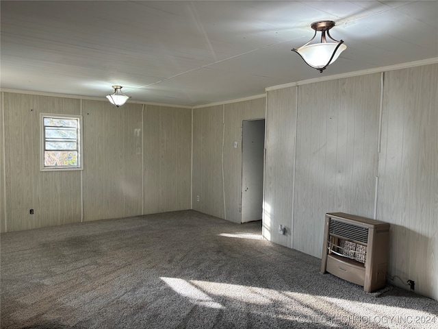 carpeted empty room with heating unit and crown molding