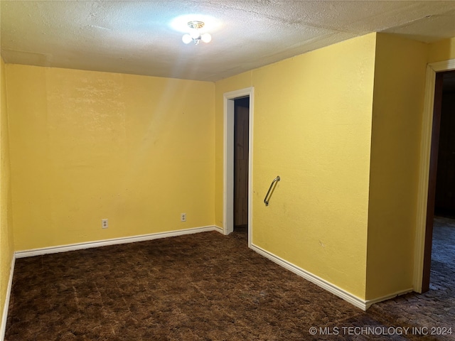 carpeted spare room featuring a textured ceiling