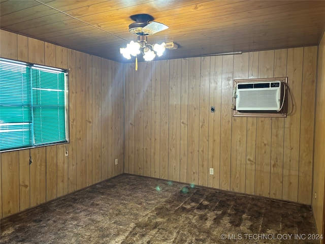 carpeted empty room with a wall unit AC, wooden walls, ceiling fan, and wood ceiling