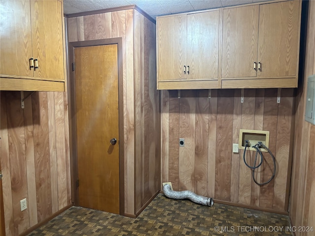 washroom featuring cabinets, dark parquet flooring, wooden walls, washer hookup, and a textured ceiling