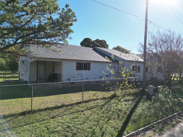 view of property exterior with a lawn