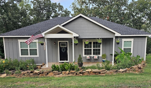 view of front of house with covered porch and a front yard