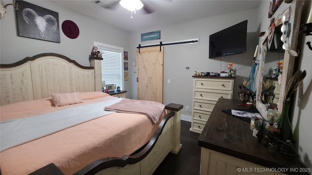 bedroom featuring a barn door and ceiling fan