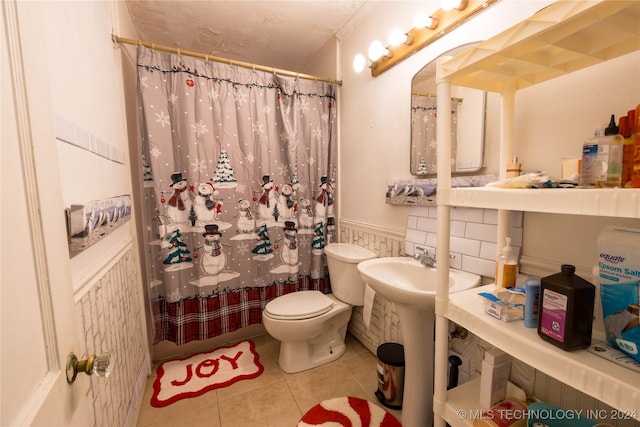 bathroom with a shower with curtain, tile patterned flooring, and toilet