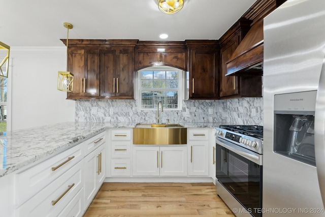 kitchen featuring backsplash, sink, light wood-type flooring, white cabinetry, and stainless steel appliances