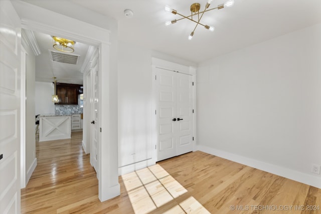 interior space with a chandelier and light wood-type flooring