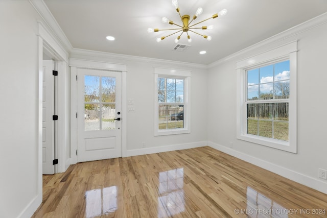 doorway to outside featuring light hardwood / wood-style floors, ornamental molding, and a chandelier