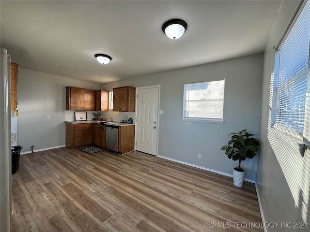 kitchen with hardwood / wood-style floors and stainless steel dishwasher