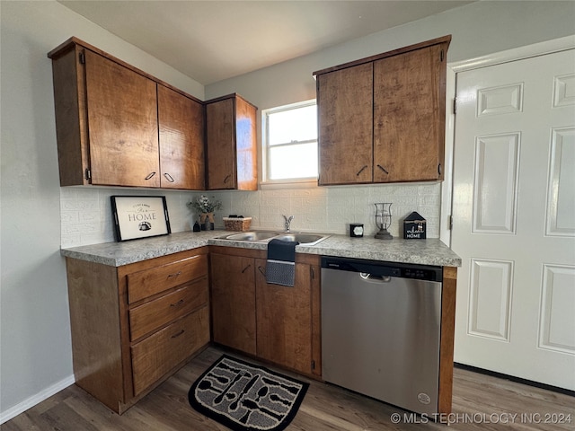 kitchen featuring tasteful backsplash, dishwasher, and light hardwood / wood-style floors