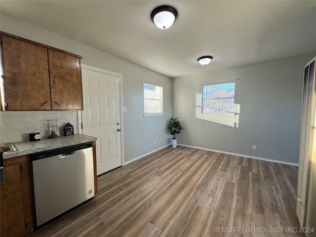 kitchen with dishwasher, decorative backsplash, and hardwood / wood-style flooring