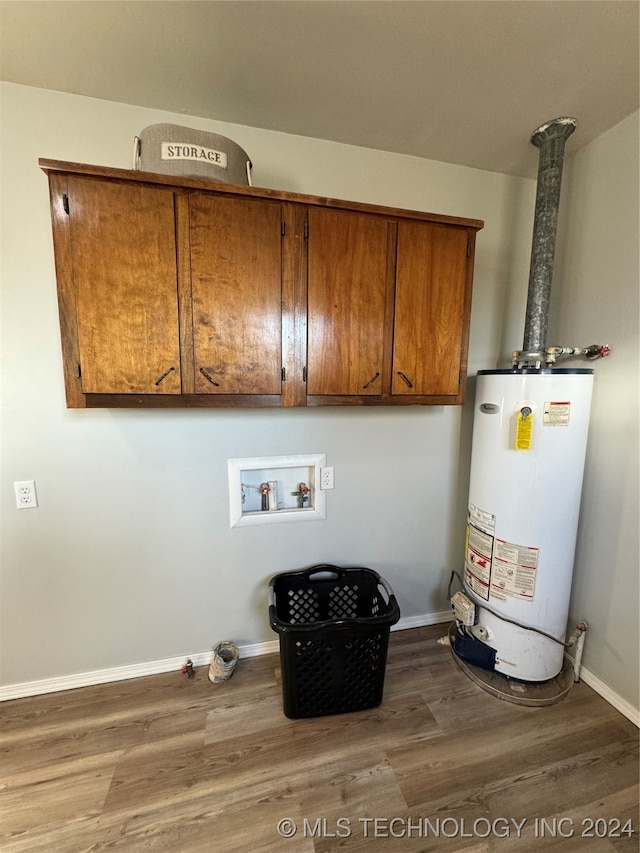 laundry area featuring hookup for a washing machine, hardwood / wood-style floors, cabinets, and gas water heater