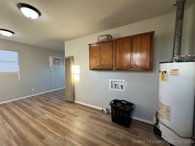 laundry area featuring cabinets, a wall mounted air conditioner, washer hookup, gas water heater, and hardwood / wood-style flooring