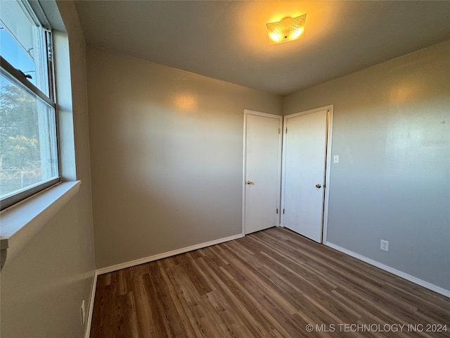 spare room with dark hardwood / wood-style flooring