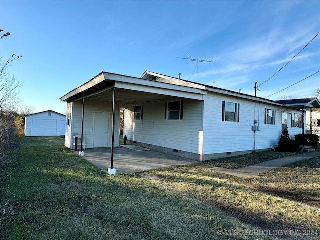 rear view of house with a carport and a yard