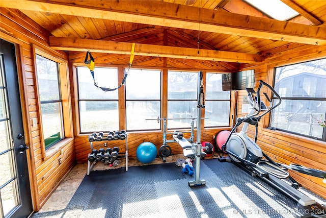 workout room featuring a healthy amount of sunlight, wooden ceiling, wooden walls, and vaulted ceiling