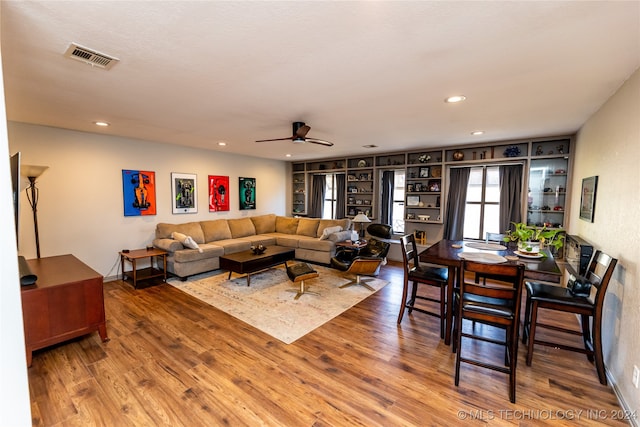 living room with ceiling fan and wood-type flooring